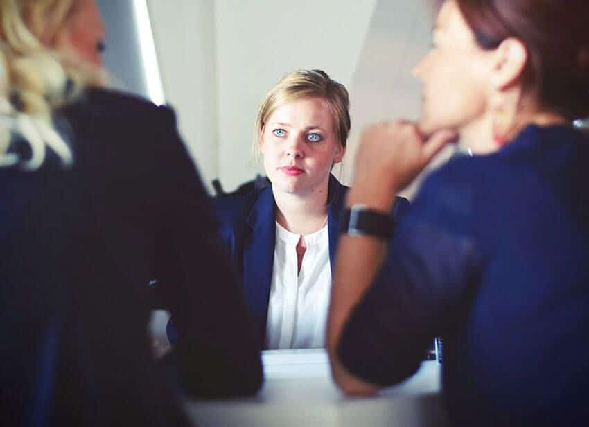 three-women-sitting-beside-table.jpg